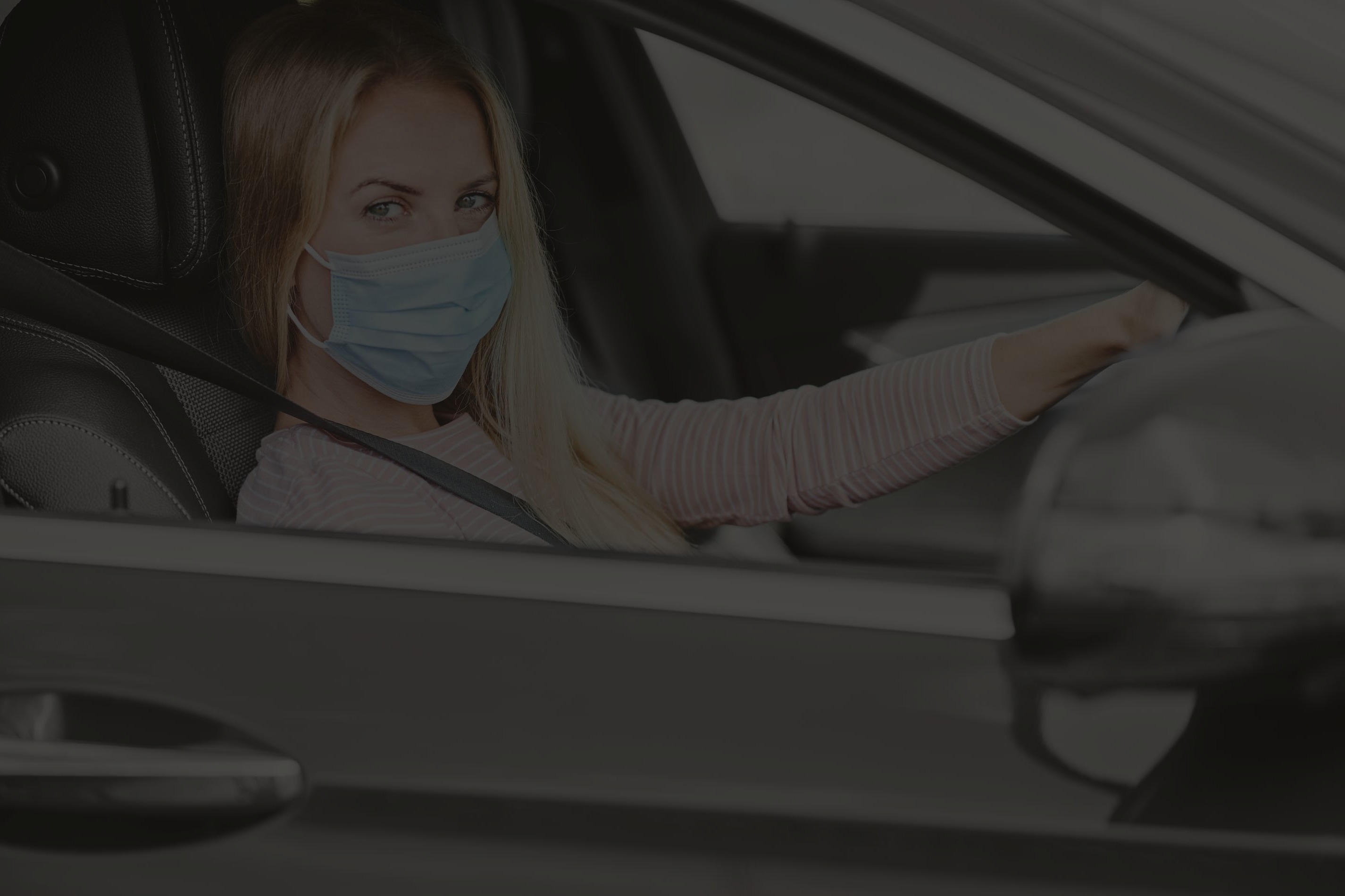 woman-in-a-protective-mask-driving-a-car